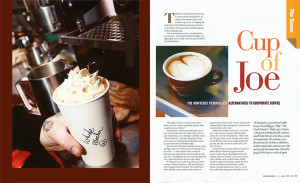 Hand holding cup of coffee in spread from Adventure magazine